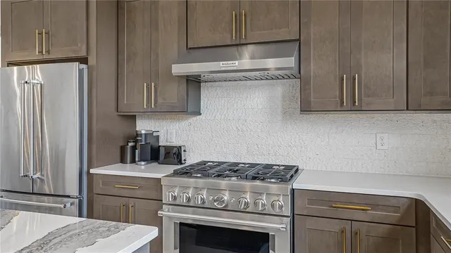 a kitchen with stove top oven and cabinets