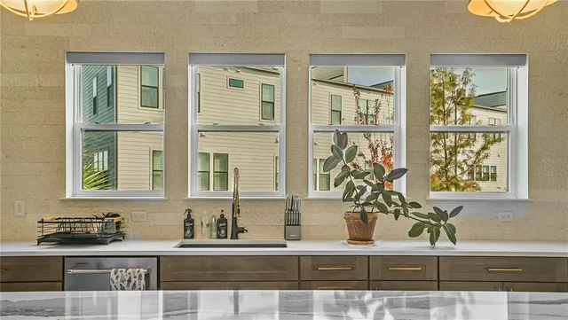 a kitchen with granite countertop a sink and a window