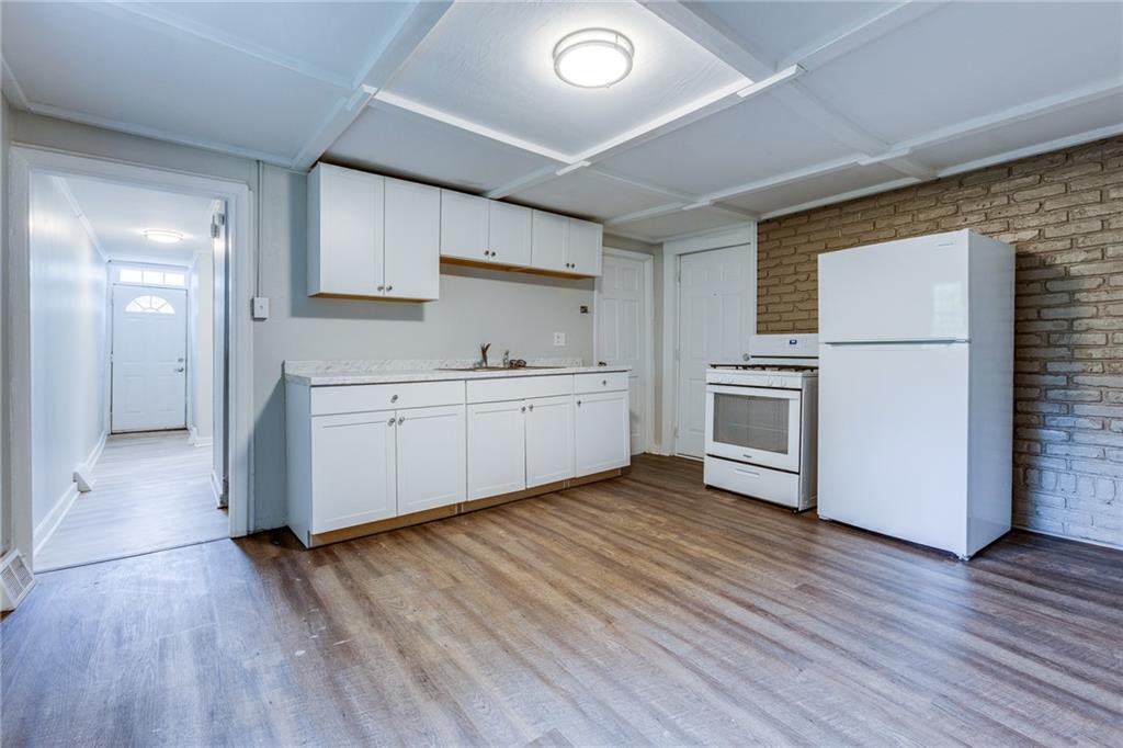 1931 Federal Street Extension Pittsburgh, PA 15212 - Photo 11 of 32 a view of a kitchen with wooden floor and electronic appliances