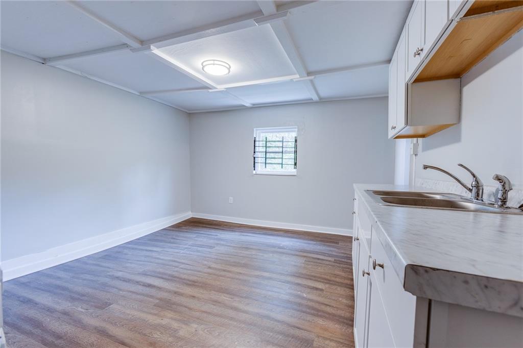 1931 Federal Street Extension Pittsburgh, PA 15212 - Photo 14 of 32 a view of a kitchen with a sink wooden floor and a window