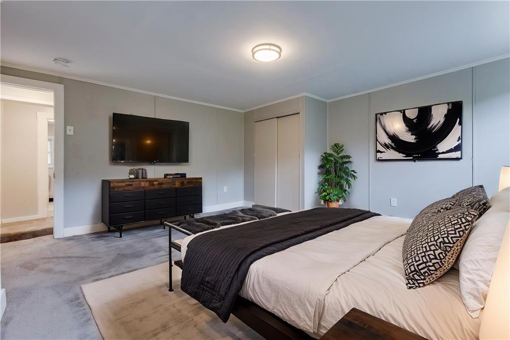 1931 Federal Street Extension Pittsburgh, PA 15212 - Photo 15 of 32 a bedroom with a bed and a flat screen tv