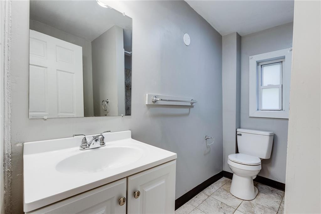 1931 Federal Street Extension Pittsburgh, PA 15212 - Photo 20 of 32 a bathroom with a sink toilet and a mirror