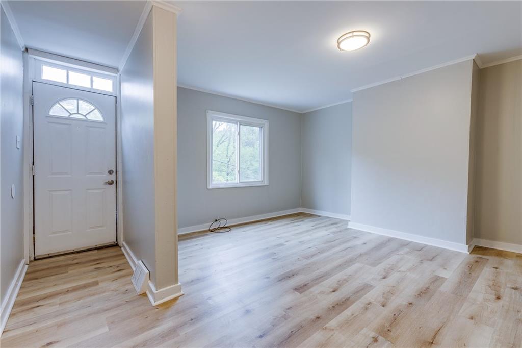 1931 Federal Street Extension Pittsburgh, PA 15212 - Photo 4 of 32 an empty room with wooden floor and windows
