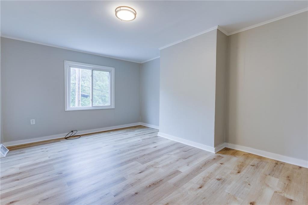 1931 Federal Street Extension Pittsburgh, PA 15212 - Photo 6 of 32 an empty room with wooden floor and windows