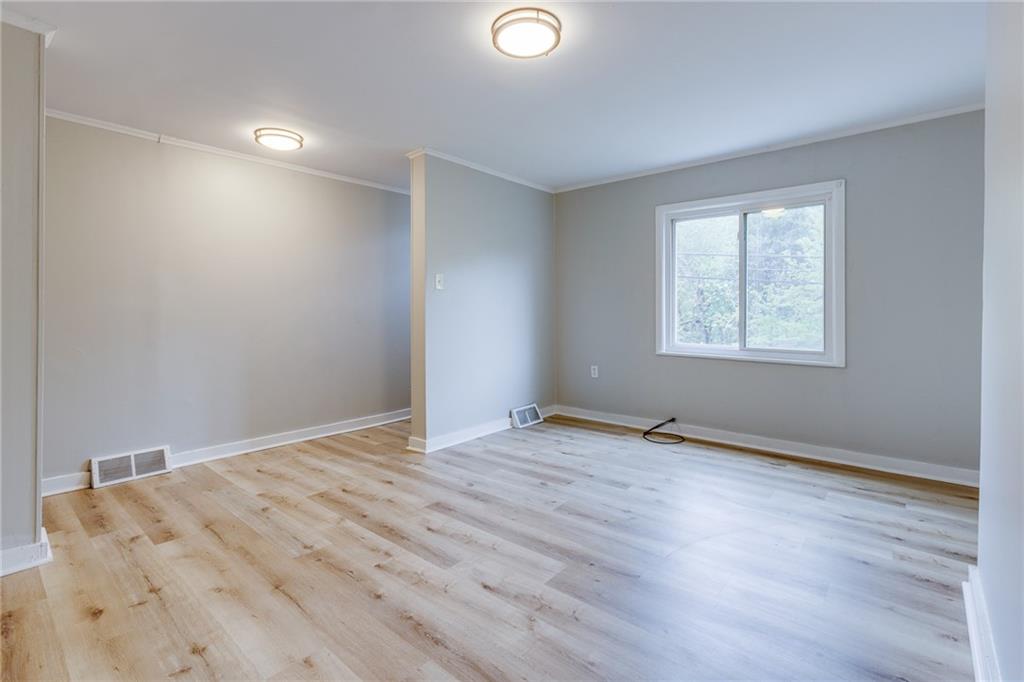 1931 Federal Street Extension Pittsburgh, PA 15212 - Photo 7 of 32 a view of an empty room with wooden floor and a window