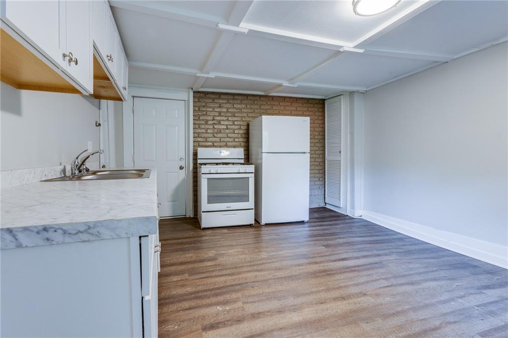 1931 Federal Street Extension Pittsburgh, PA 15212 - Photo 10 of 32 an empty room with wooden floor and cabinet
