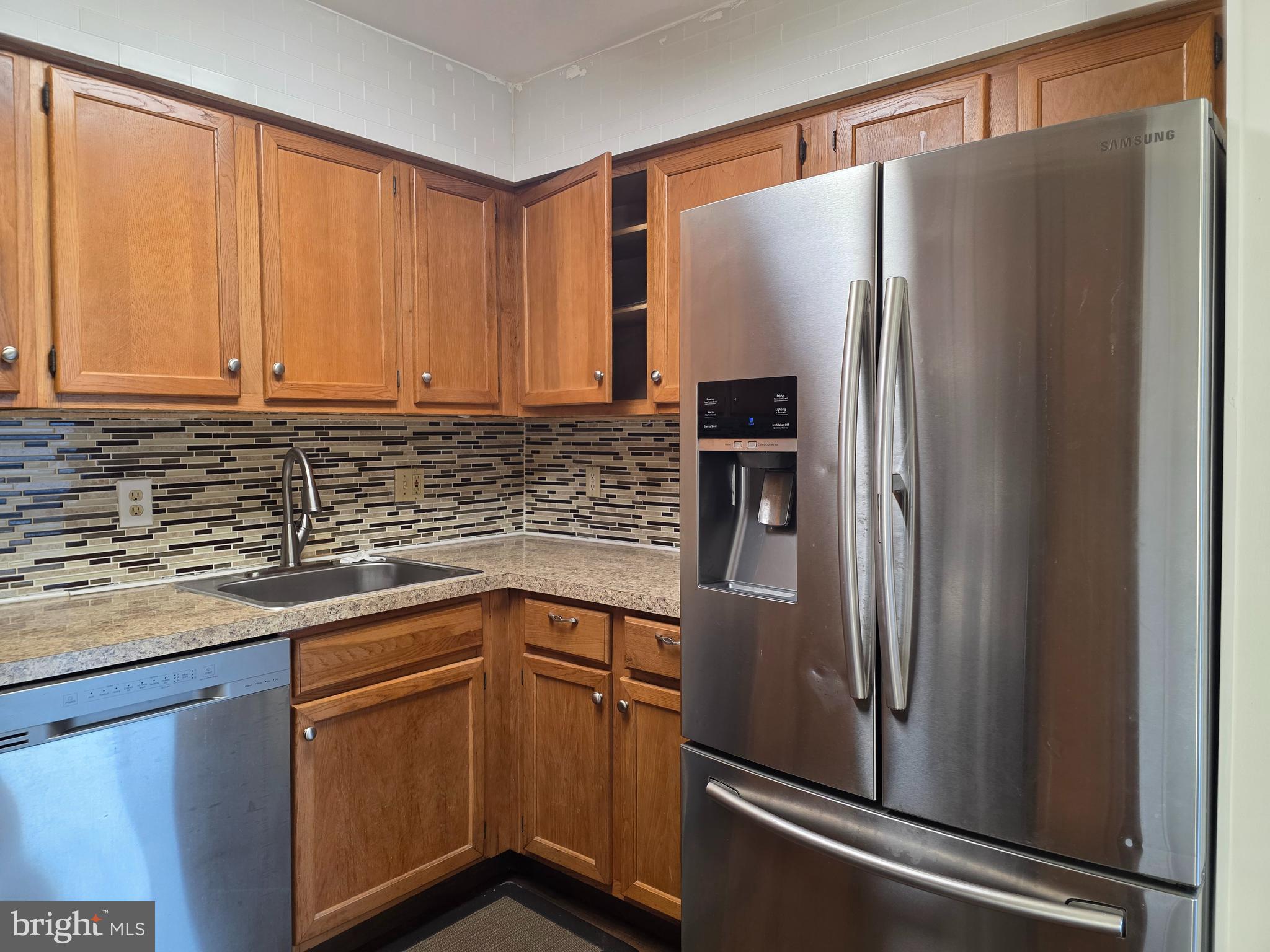 22 D Oyster Bay Absecon, NJ 08201 - Photo 13 of 13 a kitchen with stainless steel appliances granite countertop a refrigerator and a sink