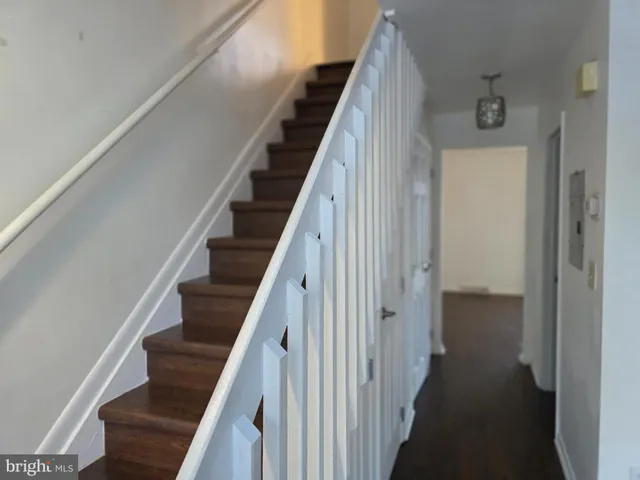 a view of a hallway with wooden floor and entryway