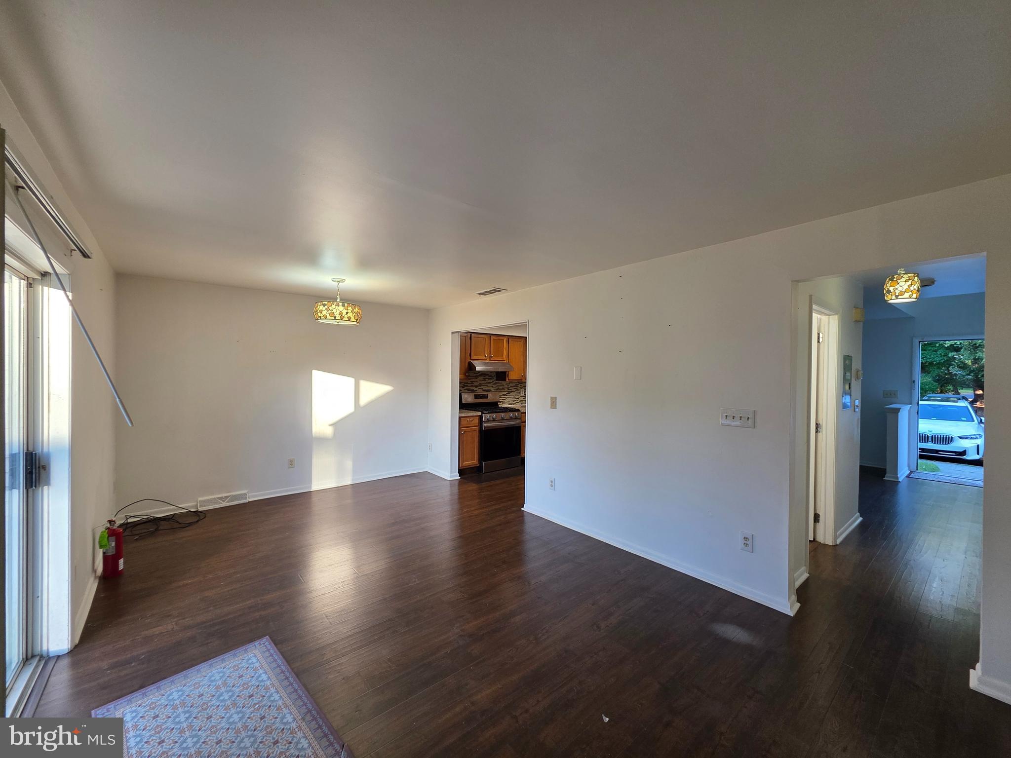 22 D Oyster Bay Absecon, NJ 08201 - Photo 4 of 13 an empty room with wooden floor and windows