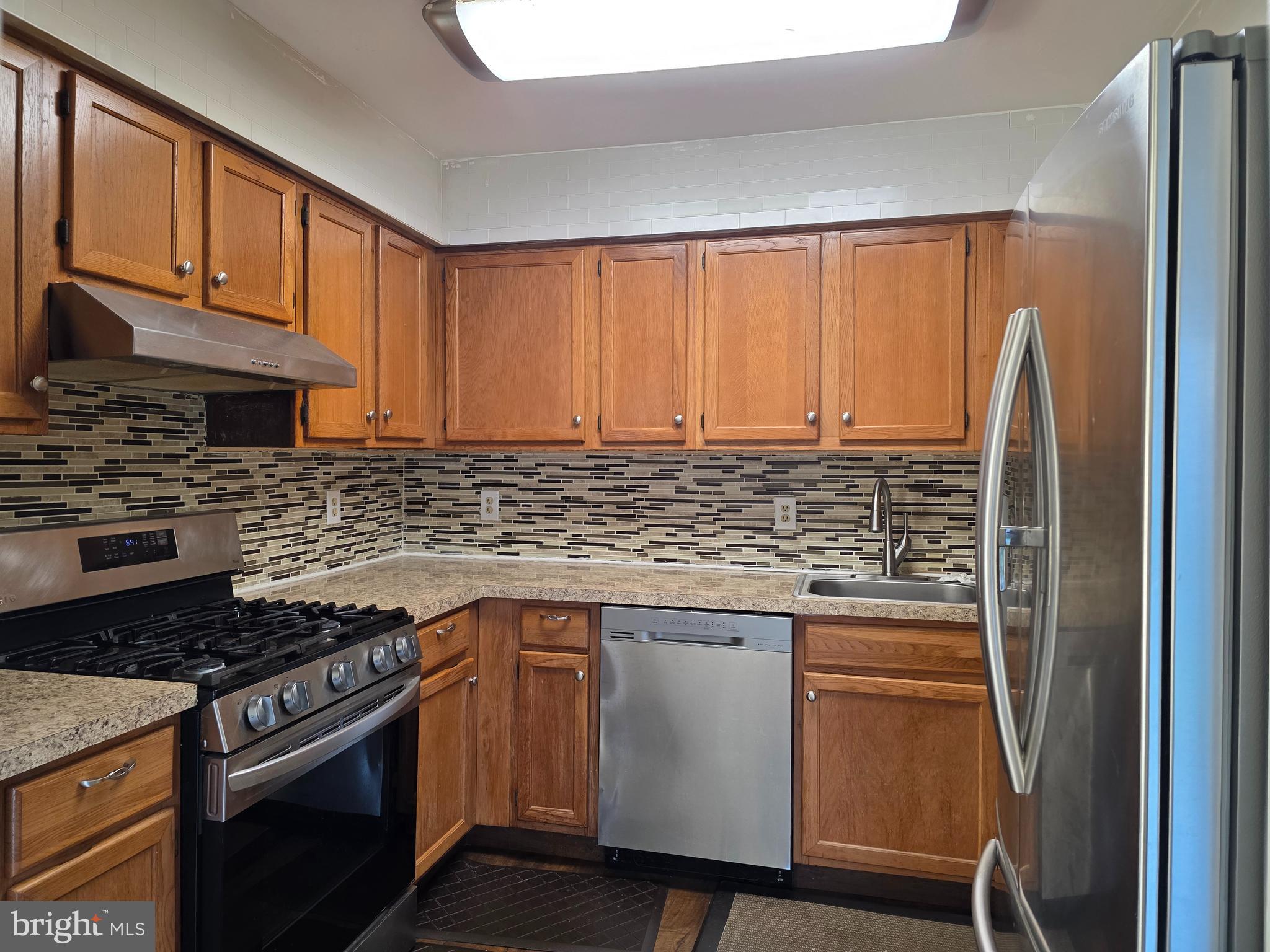 22 D Oyster Bay Absecon, NJ 08201 - Photo 6 of 13 a kitchen with a stove a sink and cabinets