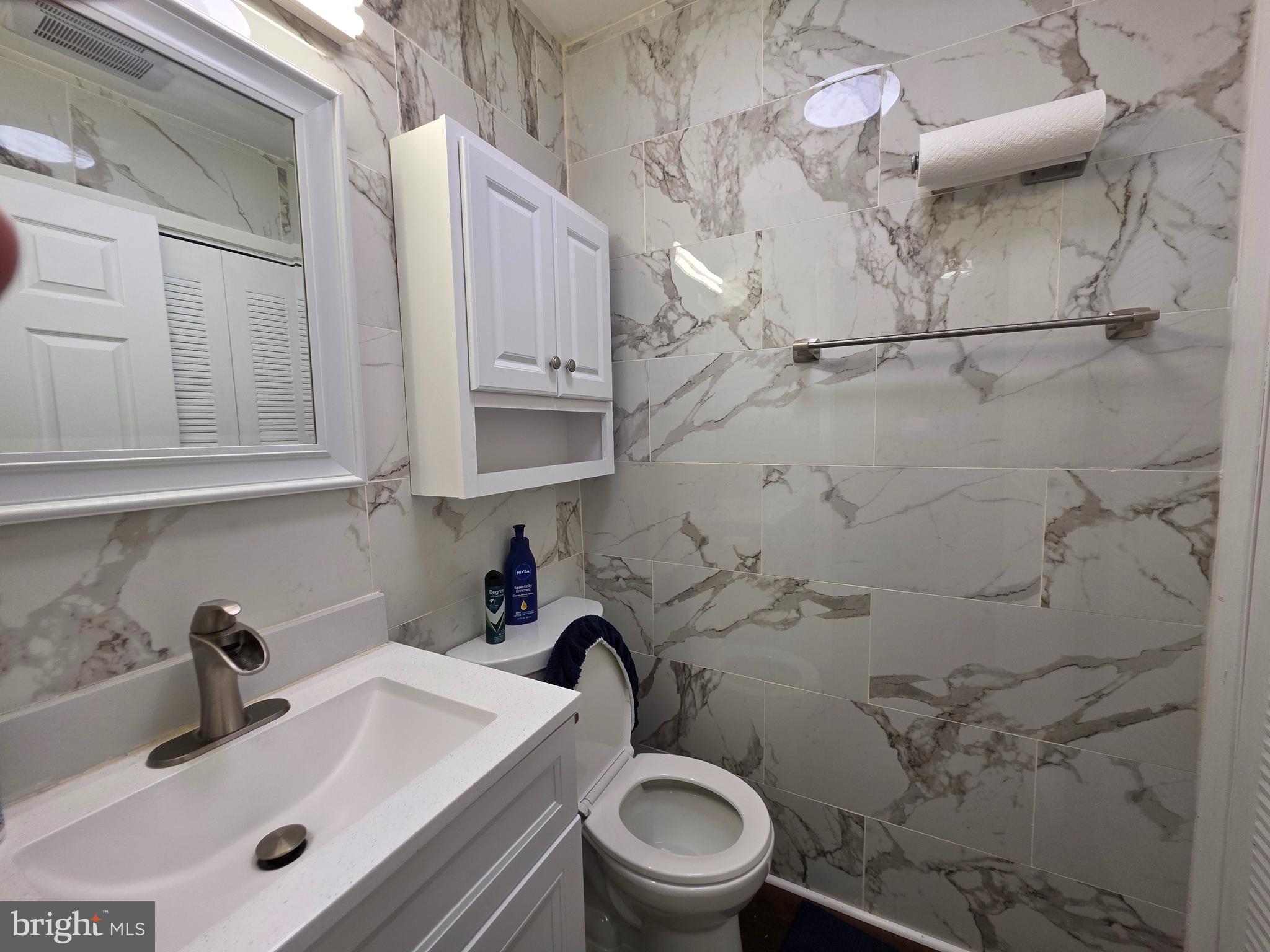 22 D Oyster Bay Absecon, NJ 08201 - Photo 7 of 13 a bathroom with a sink a toilet and shower