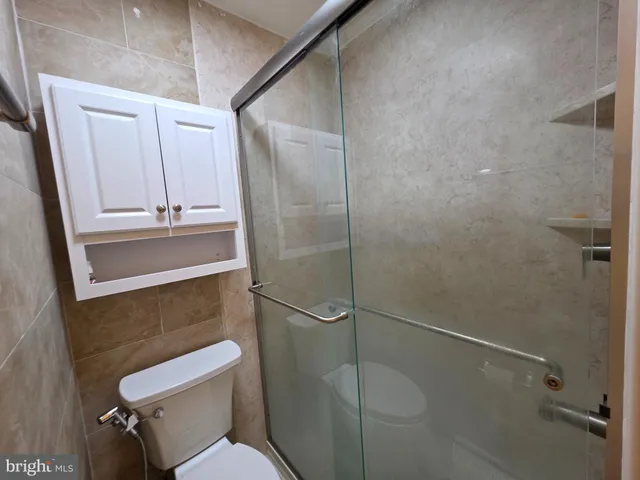 a bathroom with a shower and toilet