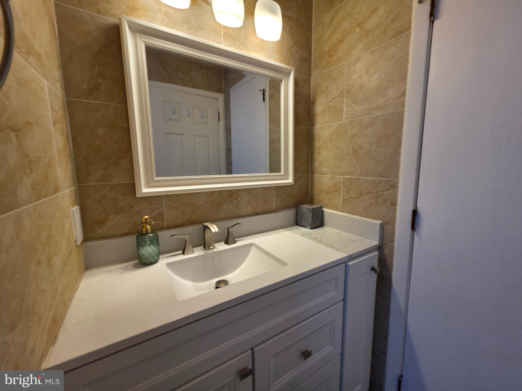 22 D Oyster Bay Absecon, NJ 08201 - Photo 9 of 13 a bathroom with a sink and a mirror