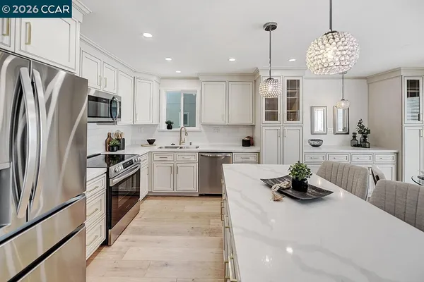 a kitchen with a sink stainless steel appliances and cabinets