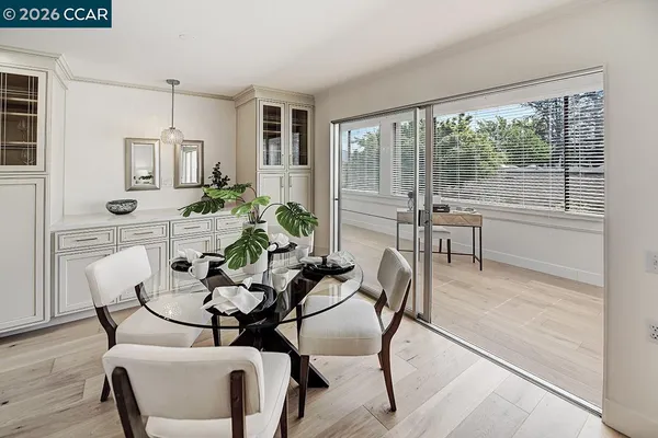 a dining room with furniture and wooden floor