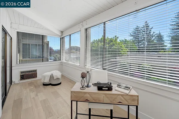 a bedroom with furniture and a window