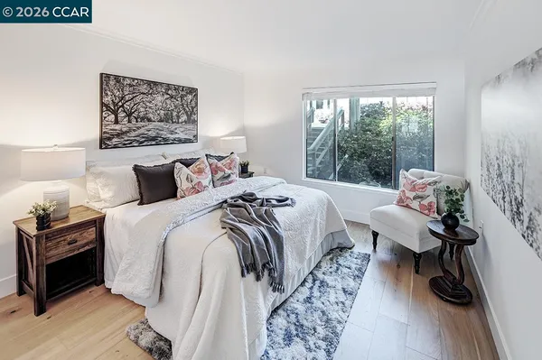 a bedroom with a bed and a painting on the wall
