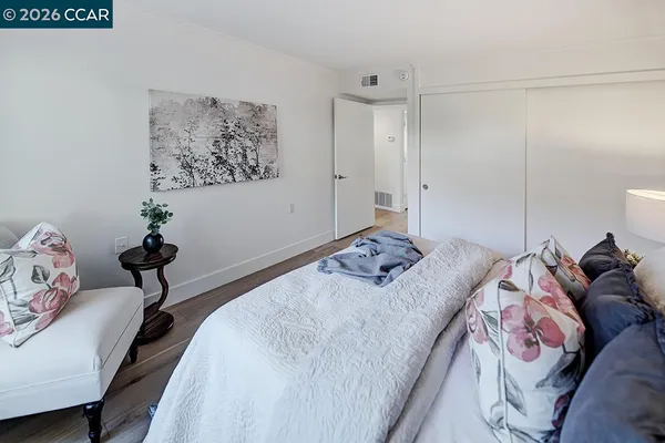 a bed room with a bed and a chair