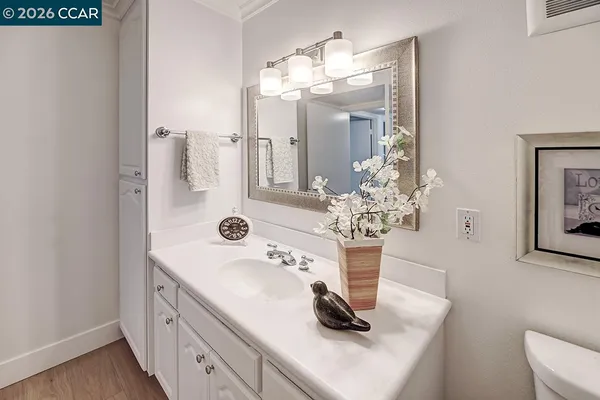 a bathroom with a sink a vanity and a mirror