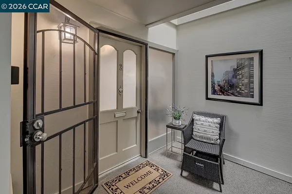a view of a hallway with furniture and front door