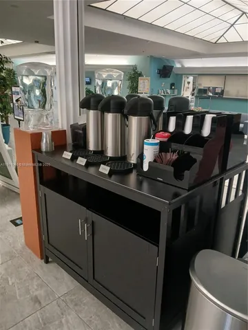 a living room with furniture a flat screen tv and a floor to ceiling window