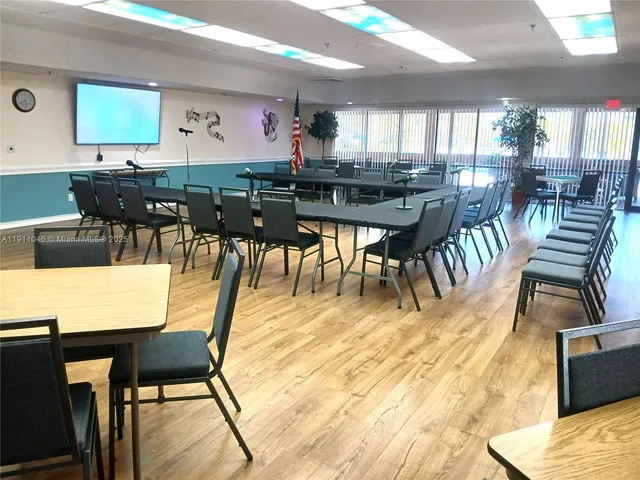 a view of a dining area with furniture and a large window