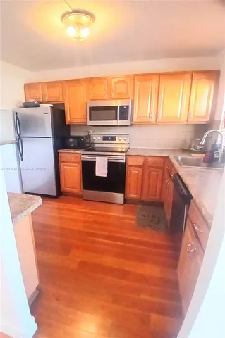 a kitchen with stainless steel appliances granite countertop a sink stove and oven