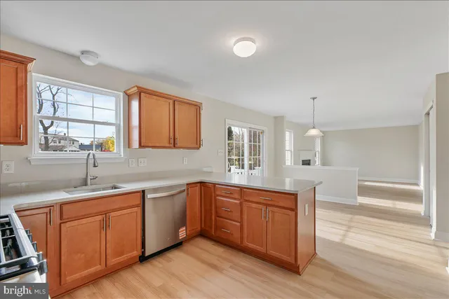 a kitchen with a sink cabinets and wooden floor