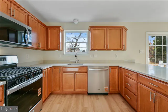 a kitchen with stainless steel appliances a sink stove and cabinets