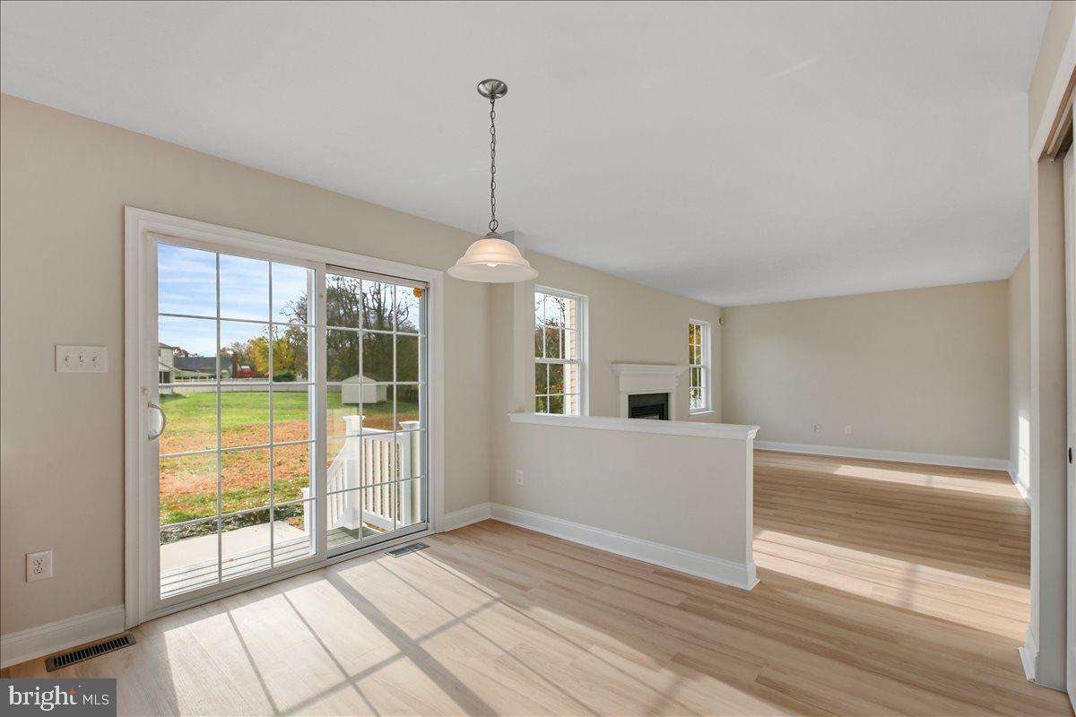 136 Kelly Driver Road Laurel Springs, NJ 08021 - Photo 13 of 35 a view of empty room with wooden floor and fireplace
