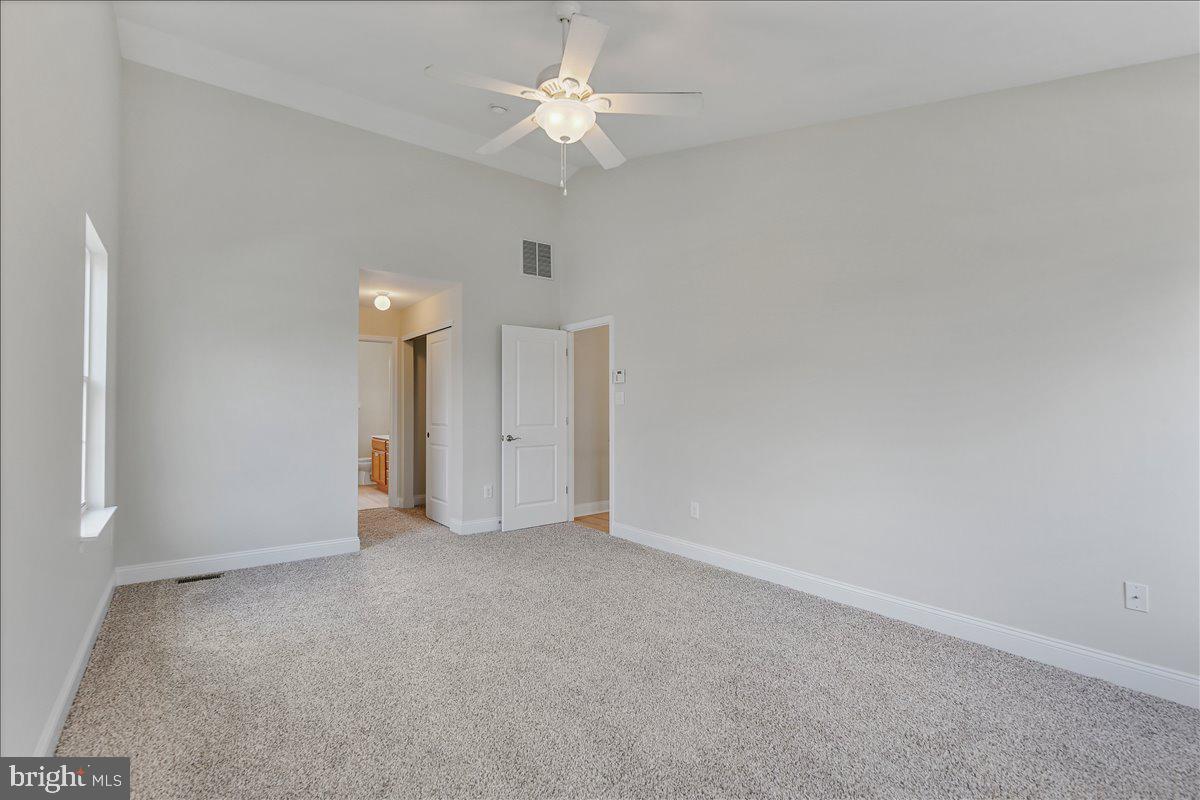 136 Kelly Driver Road Laurel Springs, NJ 08021 - Photo 22 of 35 an empty room with a ceiling fan and a window