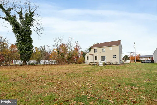 a view of a big room with a big yard and large trees