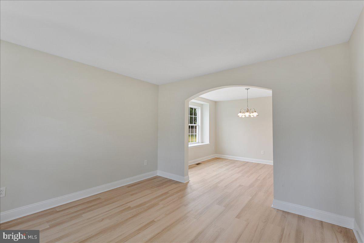 136 Kelly Driver Road Laurel Springs, NJ 08021 - Photo 7 of 35 an empty room with wooden floor and windows