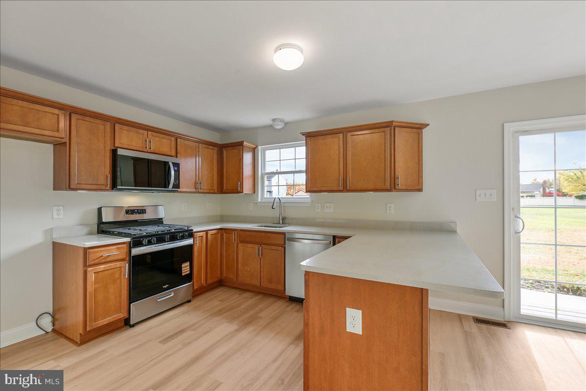 136 Kelly Driver Road Laurel Springs, NJ 08021 - Photo 10 of 35 a kitchen with stainless steel appliances granite countertop a stove a sink and a microwave