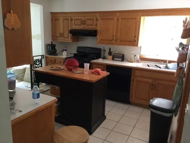 a kitchen with a sink appliances and cabinets