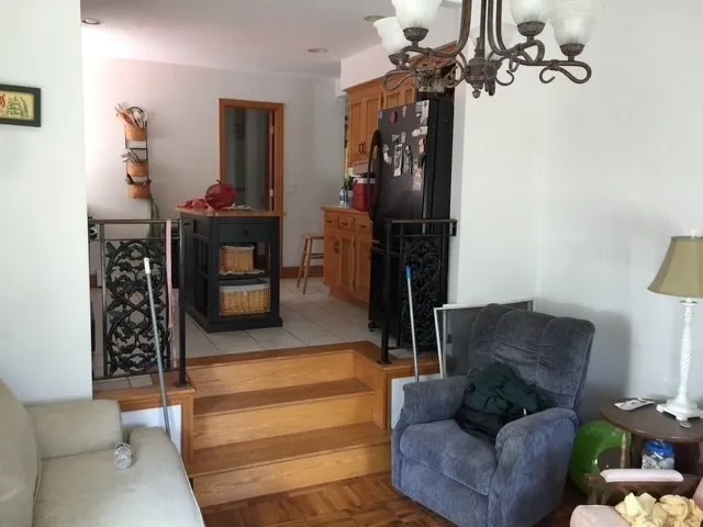 a living room with furniture and a chandelier