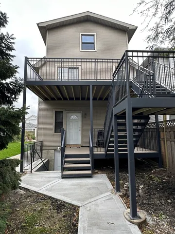 a front view of a house with entryway and stairs
