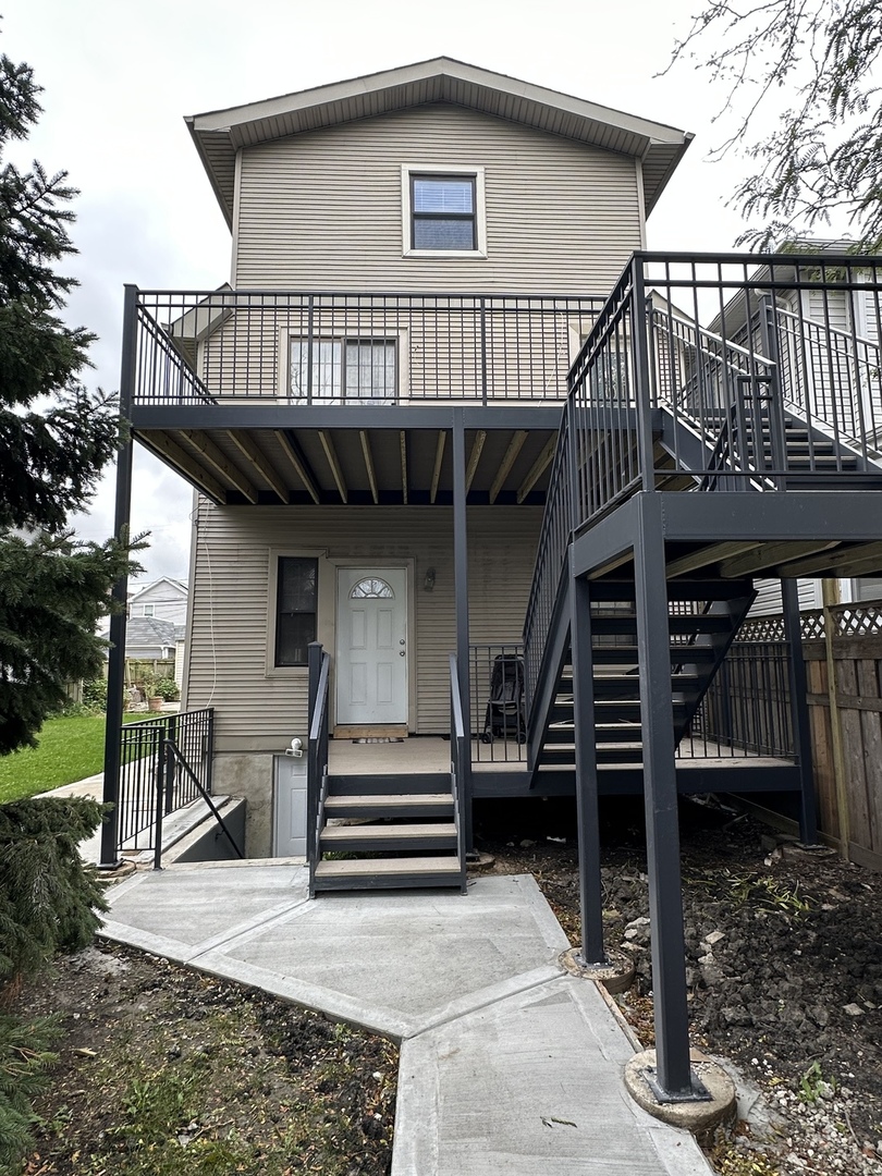 a front view of a house with entryway and stairs