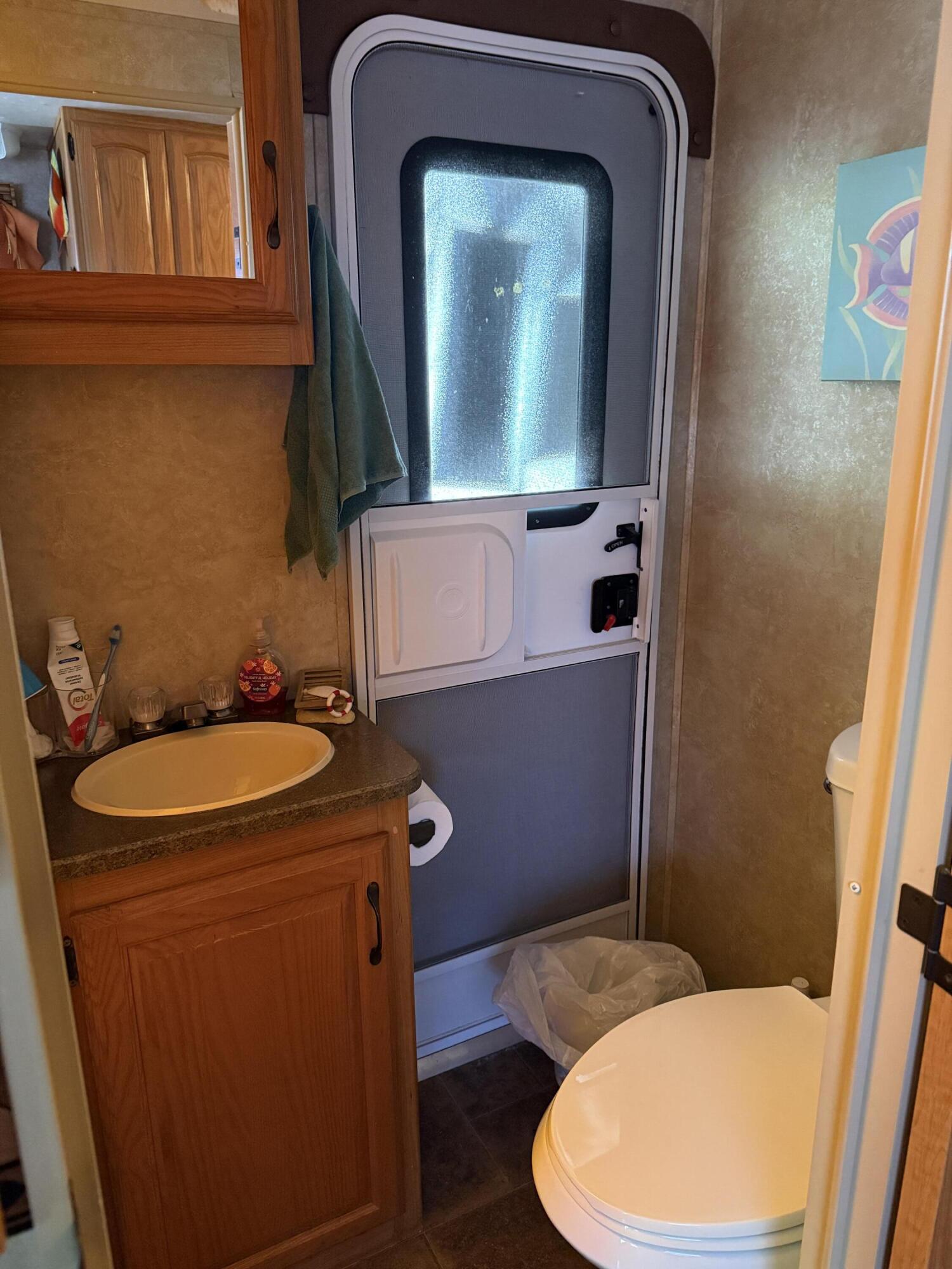 325 Calusa Street, Unit 393 Key Largo, FL 33037 - Photo 18 of 61 a bathroom with a toilet mirror and vanity