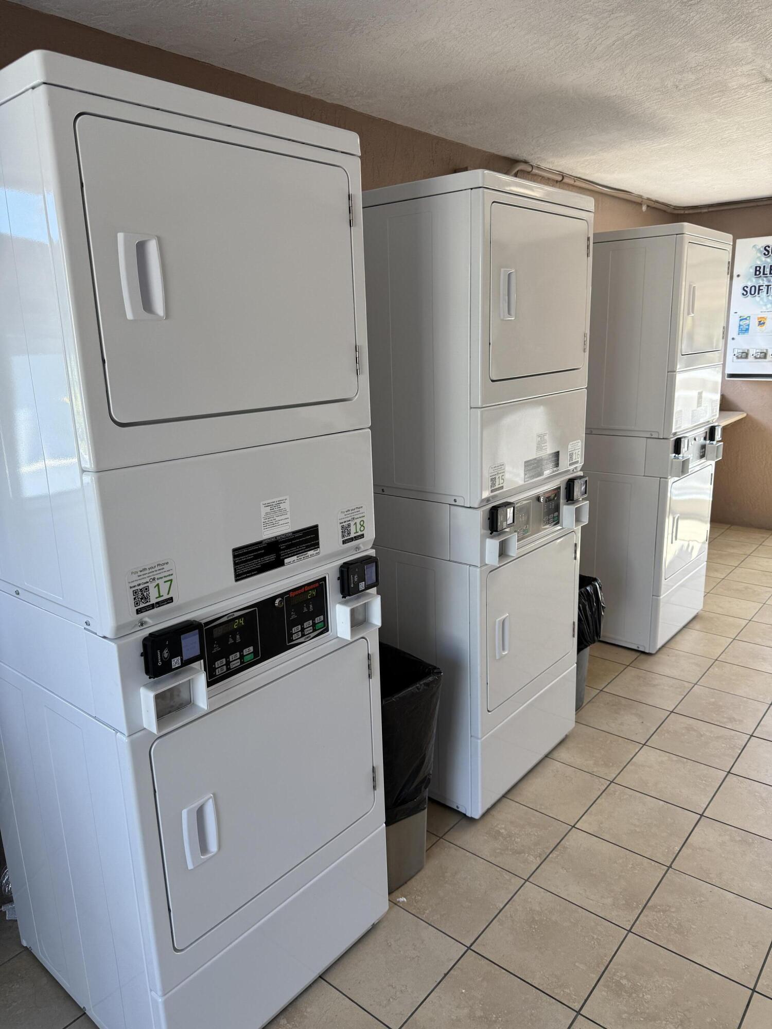 325 Calusa Street, Unit 393 Key Largo, FL 33037 - Photo 37 of 61 a kitchen with white cabinets and white appliances
