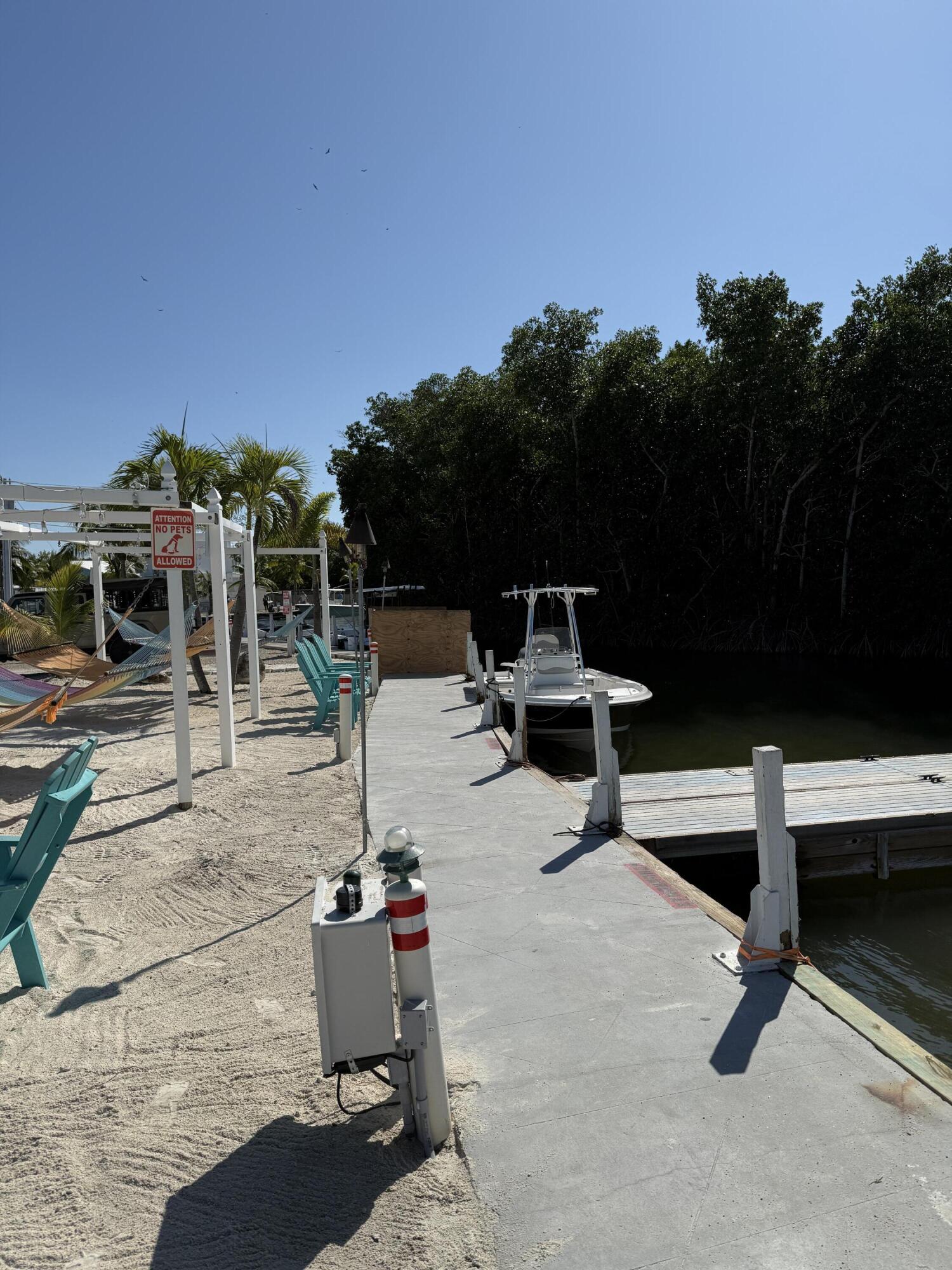 325 Calusa Street, Unit 393 Key Largo, FL 33037 - Photo 49 of 61 a view of a patio with a table and chairs