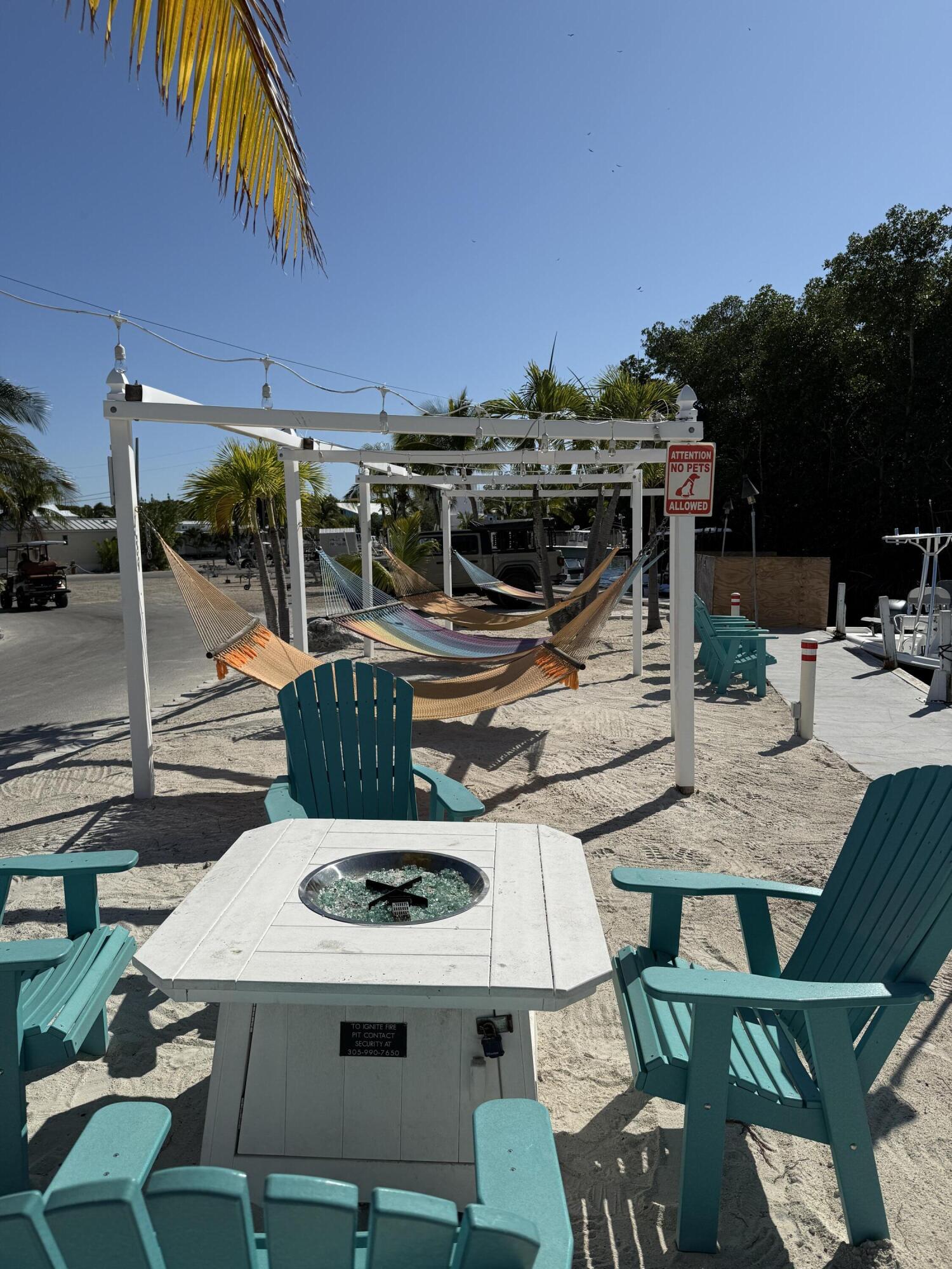 325 Calusa Street, Unit 393 Key Largo, FL 33037 - Photo 51 of 61 a view of a patio with table and chairs with wooden floor and fence