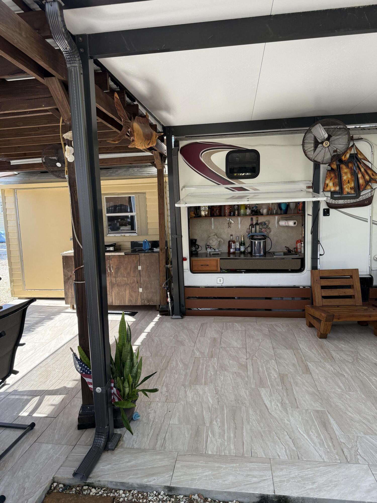 325 Calusa Street, Unit 393 Key Largo, FL 33037 - Photo 7 of 61 a view of front door and potted plants