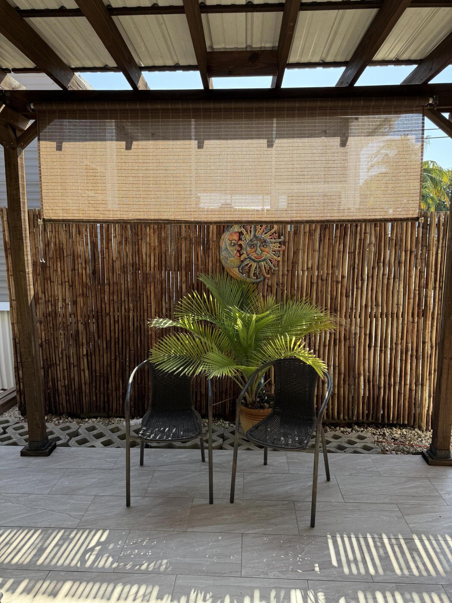 325 Calusa Street, Unit 393 Key Largo, FL 33037 - Photo 10 of 61 a building with a table and chairs