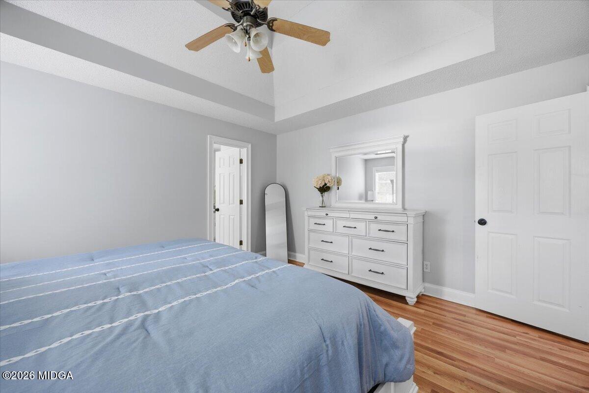 557 Aarons Circle Gray, GA 31032 - Photo 18 of 36 a bedroom with a bed and a chandelier