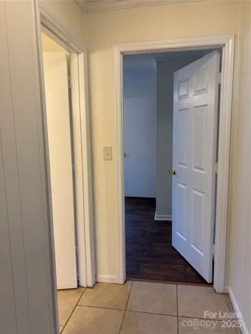 a view of a hallway with wooden floor and closet area