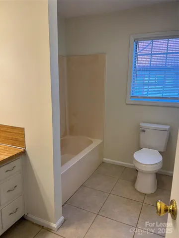a bathroom with a toilet a sink and bathtub