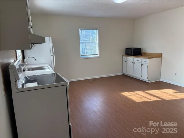 a kitchen with a cabinets and wooden floor