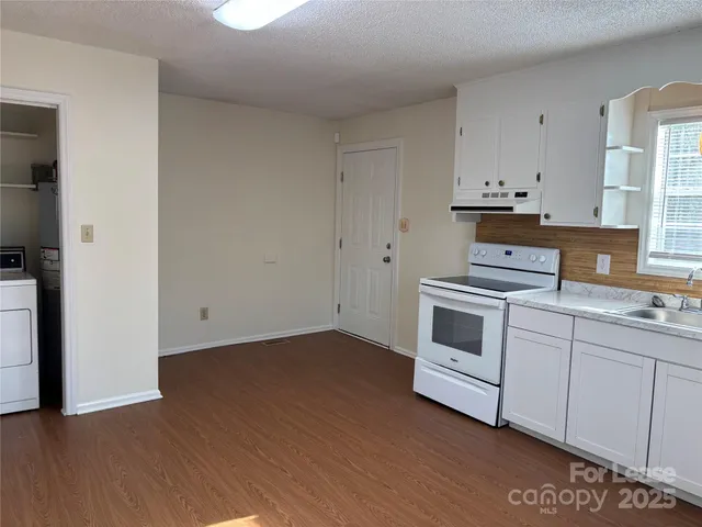 a kitchen with a white cabinets and white appliances