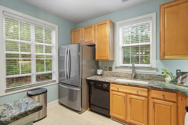 a kitchen with granite countertop a sink and a stove top oven